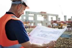 construction worker looking at a blueprint